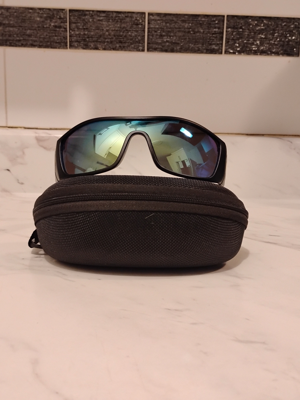 Oakley Black Frame Sunglasses with Blue-Green Mirrored Lenses